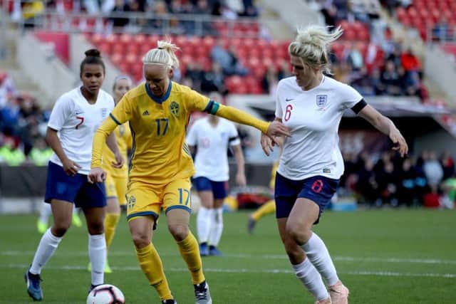 England's Millie Bright (right) and Sweden's Caroline Seger battle for the ball at the New York Stadium, Rotherham. Picture: Tim Goode/PA