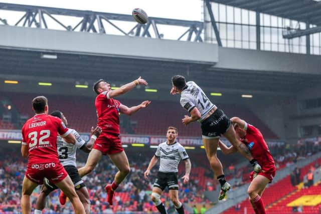 Huddersfield's Jake Wardle, left, and Hull FC's Jake Connor battle for a kick at Anfield. (PIC: Alex Whitehead/SWpix)