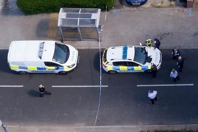 An aerial shot of police in the street at the scene of the incident