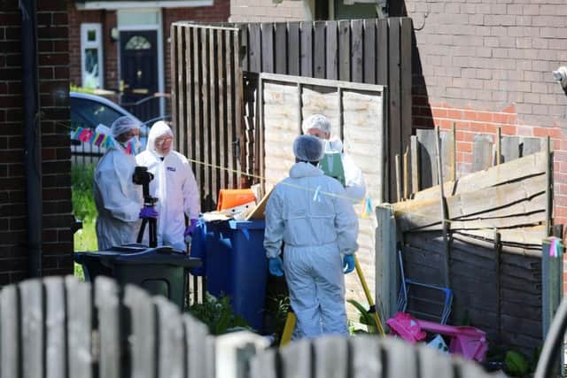Forensic officers at the scene in Sheffield