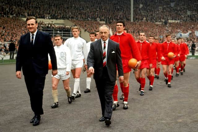 Leeds United's Don Revie (left) and Liverpool's Bill Shankly (right) lead their teams out at Wembley for the FA Cup Final in 1965. Picture: PA