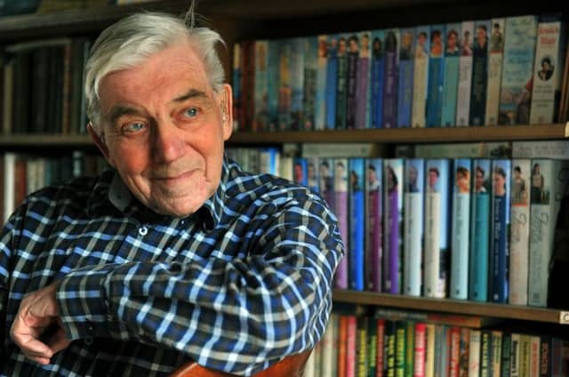 240419 Bill Spence at his home in Ampleforth in front of the many books he has written in his own name and that of Jessica Blair .