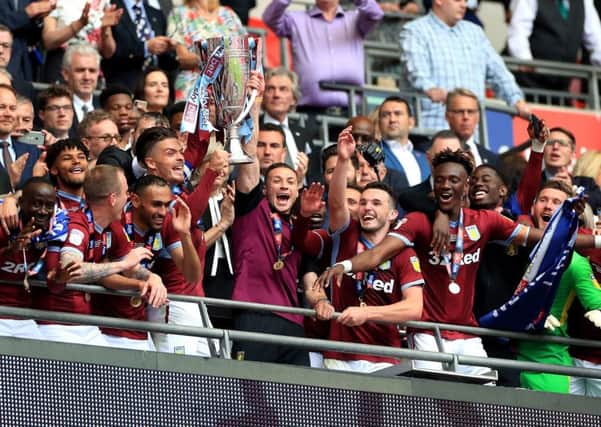 Aston Villa's Jack Grealish (centre left) and James Chester (centre right) celebrate with the trophy after winning the Sky Bet Championship Play-off final at Wembley Stadium, London. (Picture: PA).