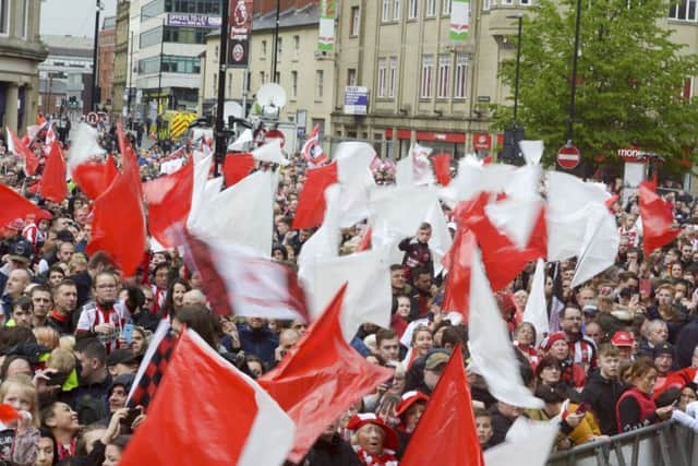 Sheffield United fans celebrate their promotion to the Premier League at Sheffield Town Hall