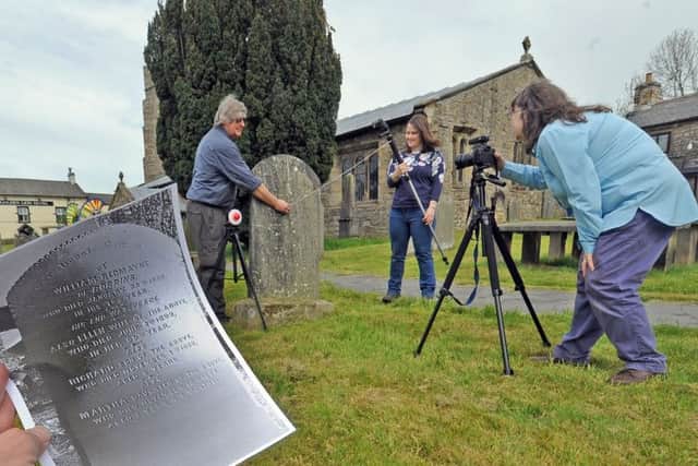 Jennifer Stearn, from the Upper Wharfedale Heritage Group using a photographic and computer software technique of RTI to help reveal illegible inscriptions on gravestones at St Oswalds Church.
