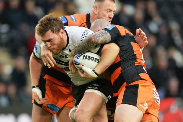Scott Taylor pushes forward with Grant Millington and Nathan Massey hanging on. as Hull FC defeated Castleford Tigers. (
Picture: Bruce Rollinson)