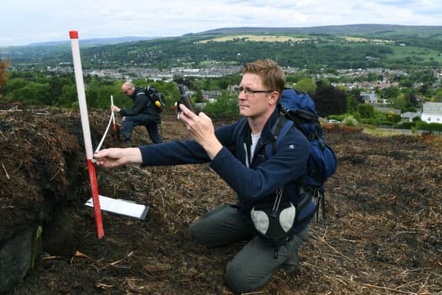 Pennine Prospects archaeologist Chris Atkinson collects data on Ilkley Moor.