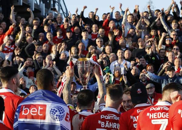 WE ARE GOING UP! Barnsley players celebrate their automatic promotion after the League One match against Bristol Rovers at the Memorial Stadium. Picture: Darren Staples/PA