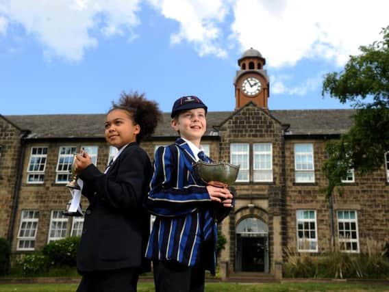 Prince Henrys Grammar School, Otley, celebrates 100 years. Pictured in the old and new uniforms are Martha Thornton aged 12 and Jack Hartis aged 12.