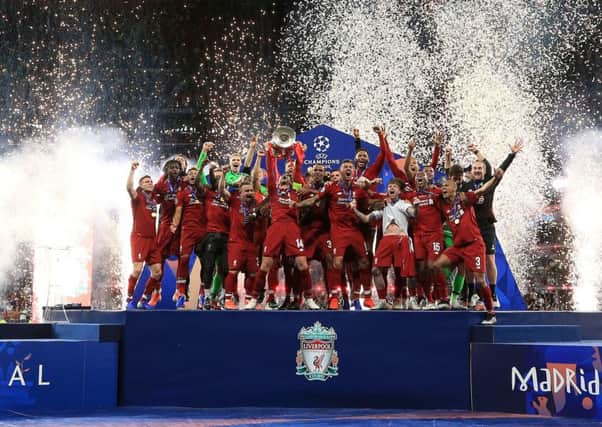 Champions: Liverpool's Jordan Henderson lifts the trophy.