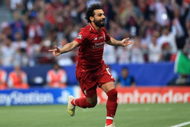Spot on: Liverpool's Mohamed Salah celebrates scoring from the penalty spot in the second minute.