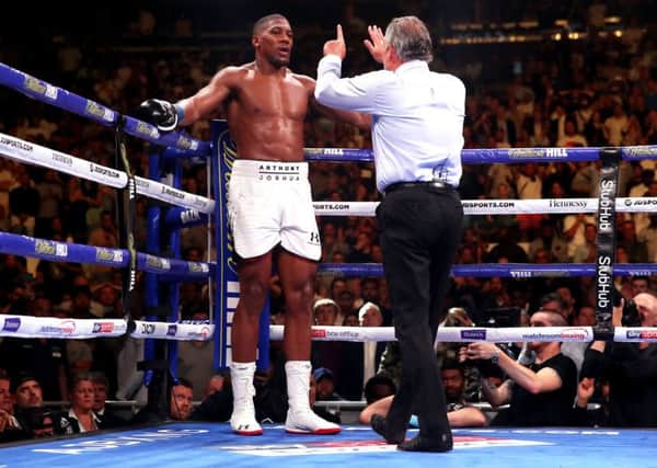 End of the road: Referee Mike Griffin counts down Anthony Joshua.