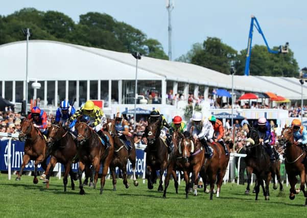 Flat out: Ornate and Phil Dennis - third left in yellow colours - win the Dash at Epsom on Derby day. Picture: Getty Images