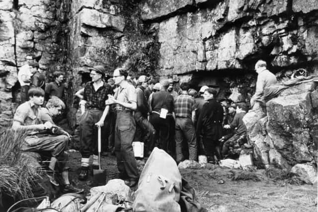 Cavers gather outside Mossdale Caverns to attempt to rescue six men who had become trapped by rising water. All perished