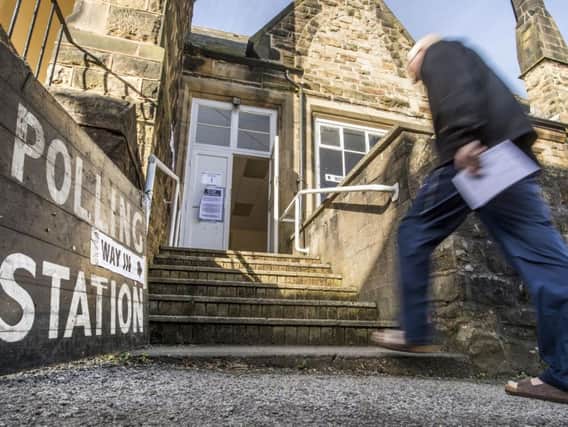 A man enters Oughtibridge parish centre polling station in Sheffield. Picture: PA