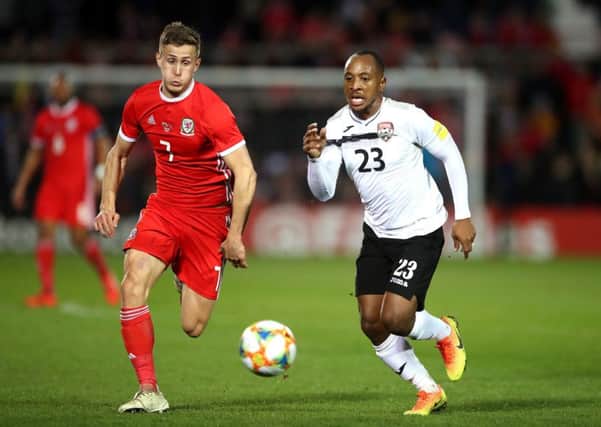 Wales' Will Vaulks (left) and Trinidad and Tobago's Leston Paul (right) battle for the ball.