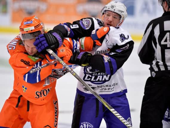 IN YOUR FACE: Brendan Connolly gets to grips with Steelers' Jonas Westerling during last year's 6-1 win for Braehead Clan in Sheffield. Picture: Dean Woolley.