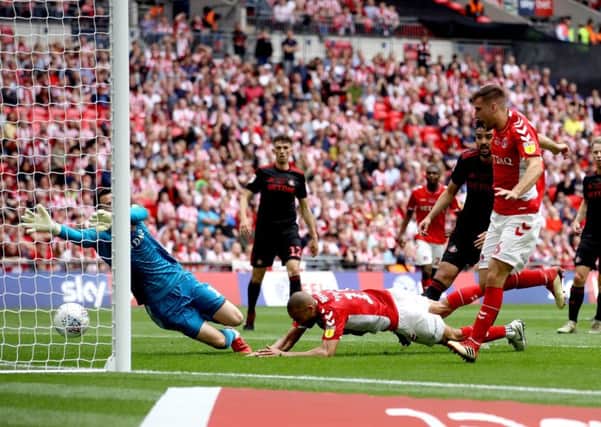 Get in: Charlton Athletic loanee Ben Purrington, second right, scores his side's first goal of the game during the League One play-off final at Wembley.