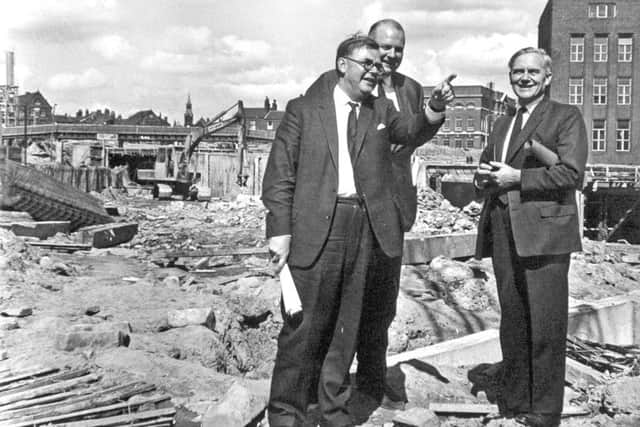 Mr. Tom Fraser (right) Minister of Transport is shown features of the Leeds Inner Ring Road now under construction, by Mr. C.G. Thirlwall, Leeds City Engineer and Planning Officer (left), when the Minister visited the site. Also in the  picture is Mr. A. T. B. Shand, Chairman of the contractors.