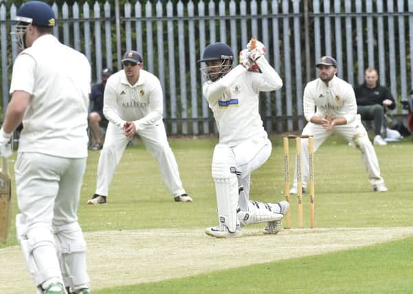 Sashin Jayawardana hits four runs on his way to making 81 for Barkisland. However, an unbeaten 99 from Jonathan Booth took Townville to victory in the Heavy Woollen Cup (Picture: Steve Riding).