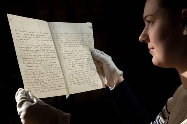 Charlotte Craig, curatorial assistant at Bronte Parsonage Museum, with the letter to Charlotte Brontë from the poet laureate, telling her that writing was no job for a woman.
Picture by Bruce Rollinson