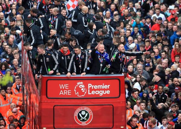 We're on our way: Sheffield United players and manager Chris Wilder wave to the fans during the promotion parade.