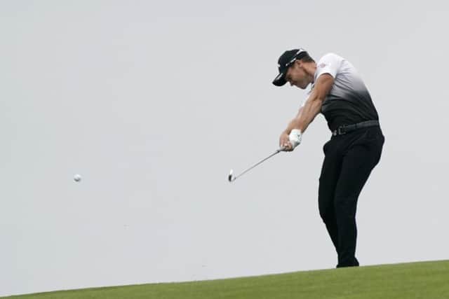 Into action: Danny Willett  hits from the fairway on the ninth.