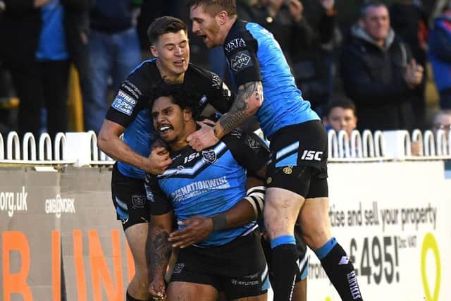 In at the treble: Hull's Albert Kelly is congratulated on his third try by Jamie Shaul and Marc Sneyd.  Picture: Jonathan Gawthorpe
