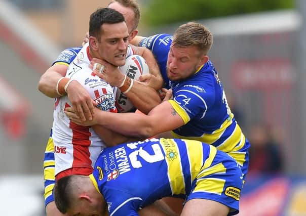New contract: Hull KR's Craig Hall, tackled during the Super League match against Warrington, is staying with Robins. Picture: Dave Howarth/PA