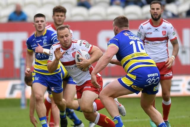 Rovers star Adam Quinlan gets away from Warrington's Mike Cooper. (Picture: Jonathan Gawthorpe)