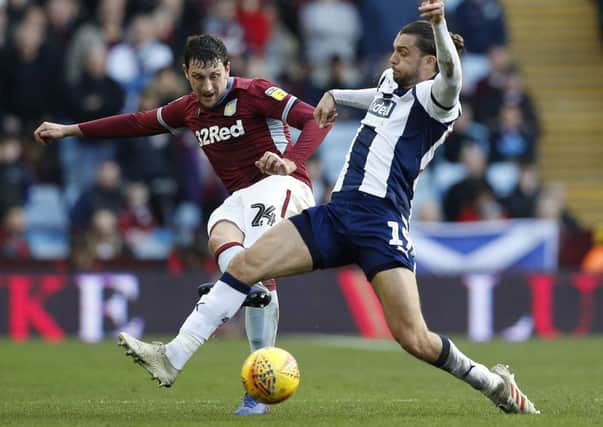 Tommy Elphick, who has signed for Huddersfield Town, seen left challenging West Bromwich Albion's Jay Rodriguez while playing for Aston Villa (Picture: Darren Staples/PA Wire).