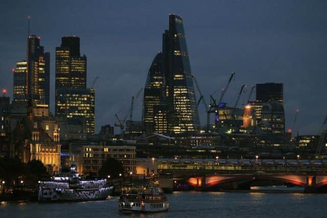 The City of London skyline at dusk, with Blackfriars Bridge in the foreground. The FTSE 100 Index will open Tuesday morning after one of the darkest days in its recent history  as fears of China's growth slowdown spread across the globe  PRESS ASSOCIATION Photo. Picture date: Monday August 24, 2015. See PA story CITY FTSE. Photo credit should read: Jonathan Brady/PA Wire