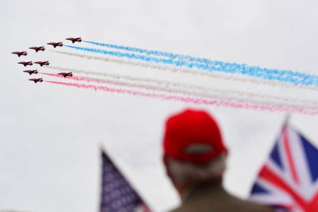A man watches a Red Arrows display during the commemorations for the 75th Anniversary of the D-Day landings at Southsea Common in Portsmouth.