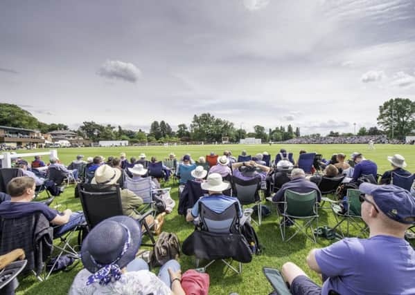 Supporters watch on as Yorkshire play Warwickshire at York's Clifton Park Cricket Club.