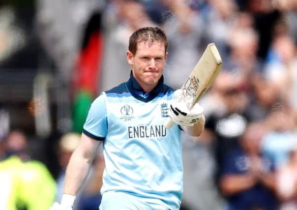 England's Eoin Morgan raises his bat after reaching a century at Old Trafford. Picture: Martin Rickett/PA