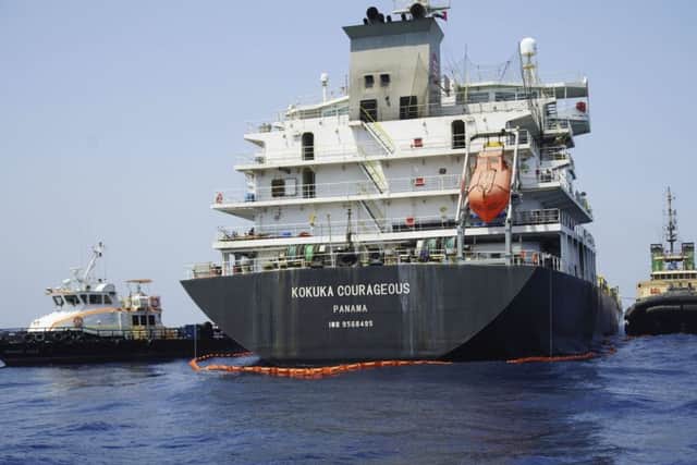 The damaged Panama-flagged, Japanese owned oil tanker Kokuka Courageous is anchored off Fujairah. The limpet mines used to attack the oil tanker near the Strait of Hormuz bore "a striking resemblance" to similar mines displayed by Iran, a U.S. Navy explosives expert said. Iran has denied being involved.