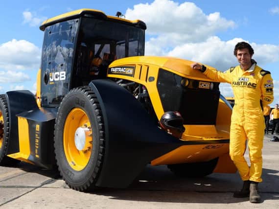 Guy Martin, pictured next to the JCB Fastrac tractor he drove to a new British speed record near York.
