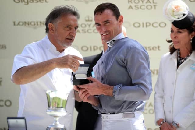 On the menu: Chef Raymond Blanc presents Danny Tudhope with his prize after Space Traveller's win in the Jersey Stakes.