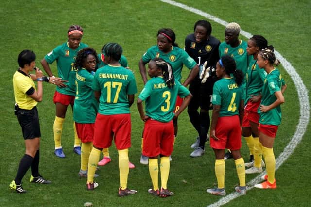Cameroon players stand in a huddle on the pitch after England's Ellen White scores a goal which is originally given as offside but then allowed by VAR. Picture: John Walton/PA