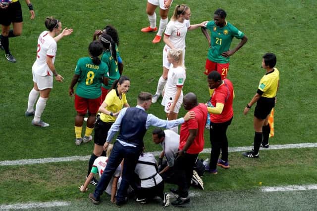 Match referee Qin Liang intervenes after Cameroon's Alexandra Takounda (21) fouls England's Steph Houghton (obscured) and England head coach Phil Neville (bottom left) and Cameroon head coach Alain Djeumfa (bottom right) exchange words. Picture: John Walton/PA