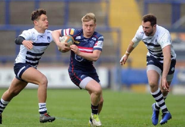 Doncaster Knights' Cameron Cowell goes past Yorkshire Carnegie's Sam Wolstenholme and Andrew Forsyth.