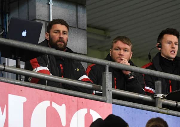 Grant McCann and Paul Gerrard watch from the stands.