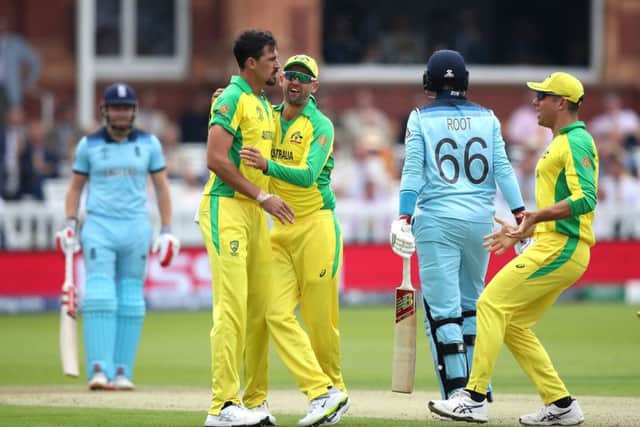 Australia's Mitchell Starc (left) celebrates taking the wicket of England's Joe Root at Lord's. Picture: Tim Goode/PA