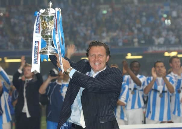 Job done: Huddersfield Town manager Peter Jackson celebrates promotion after beating Mansfield Town in a penalty shootout in the Nationwide Division Three play-off final in Cardiff in 2004.
