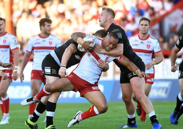 STAY TOUGH: Hull KR's Weller Hauraki is tackled by Hull's Scott Taylor and Joe Westerman, who later put his dislocated knee back in place on the pitch. Picture: Jonathan Gawthorpe