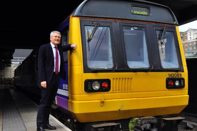 Rail Minister Andrew Jones with a Pacer train - the ageing fleet will now stay in service until next year due to delays introducing new rolling stock on the Northern network.