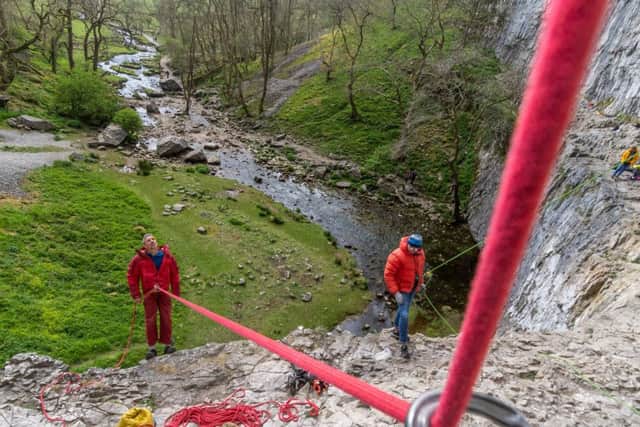 Date: 10th May 2019.
Pivcture James Hardisty.
Climbing feature at one of the UK's best climbing walls Malham Cove, in the heart of the Yorkshire Dales, near Skipton. Pictured Sport climber Steve McClure, guiding and supporting a climbing friend as he tries to ascend the near vertical cliff face of Malham Cove.