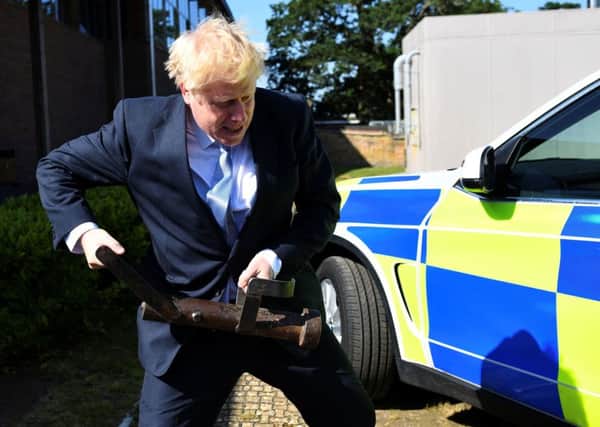 Conservative party leadership candidate Boris Johnson holds a battering ram during a visit to the Thames Valley Police Training Centre in Reading, Berkshire, on Wednesday. He cancelled a promised interview with The Yorkshire Post.