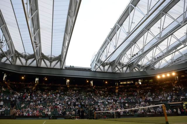 Play is temporarily suspended as the roof is closed on centre court during the Ladies doubles final on day Twelve of the Wimbledon Championships at the All England Lawn Tennis and Croquet Club, Wimbledon. PRESS ASSOCIATION Photo. Picture date: Saturday July 11, 2015.  See PA Story TENNIS Wimbledon. Photo credit should read: Andrew Matthews/PA Wire. RESTRICTIONS: Editorial use only. No commercial use without prior written consent of the AELTC. Still image use only - no moving images to emulate broadcast. No superimposing or removal of sponsor/ad logos. Call +44 (0)1158 447447 for further information.