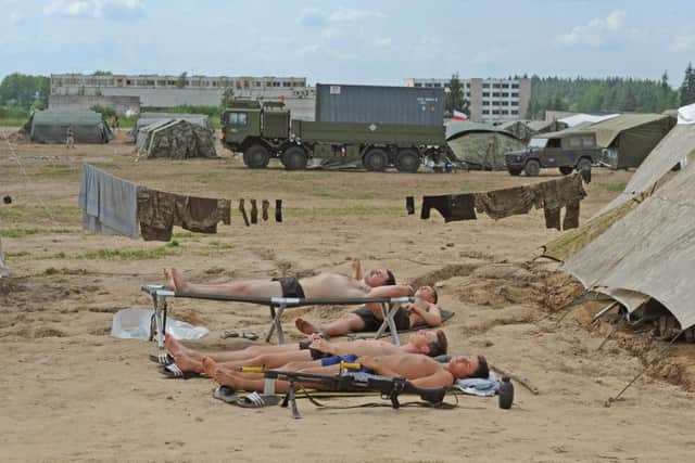 Soldiers enjoy some downtime in camp. Picture: Tony Johnson